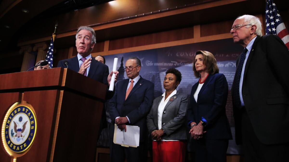 Rep. Richard Neal (D-Mass.), joined by Senate Minority Leader Chuck Schumer (D-N.Y.), Rep. Barbara Lee (D-Oakland), House Minority Leader Nancy Pelosi (D-San Francisco) and Sen. Bernie Sanders (I-Vt.), speaks during a news conference on Capitol Hill on Oct. 4, 2017.