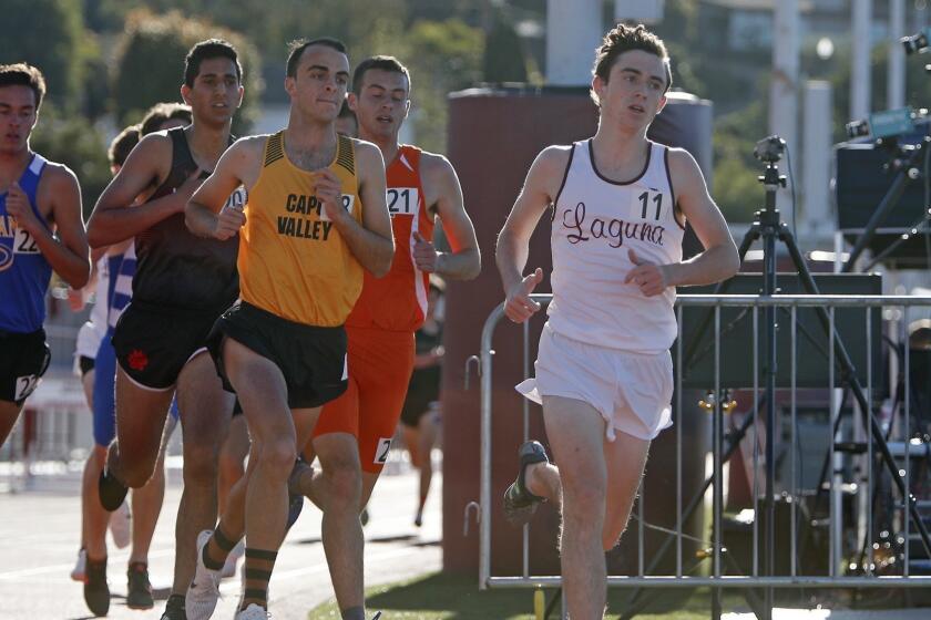 Laguna Beach High's Ryan Smithers (11) runs in the Eric Hulst boys' 3,200-meter race during the Laguna Beach Trophy Invitational at Laguna Beach High on Saturday, March 16, 2019.