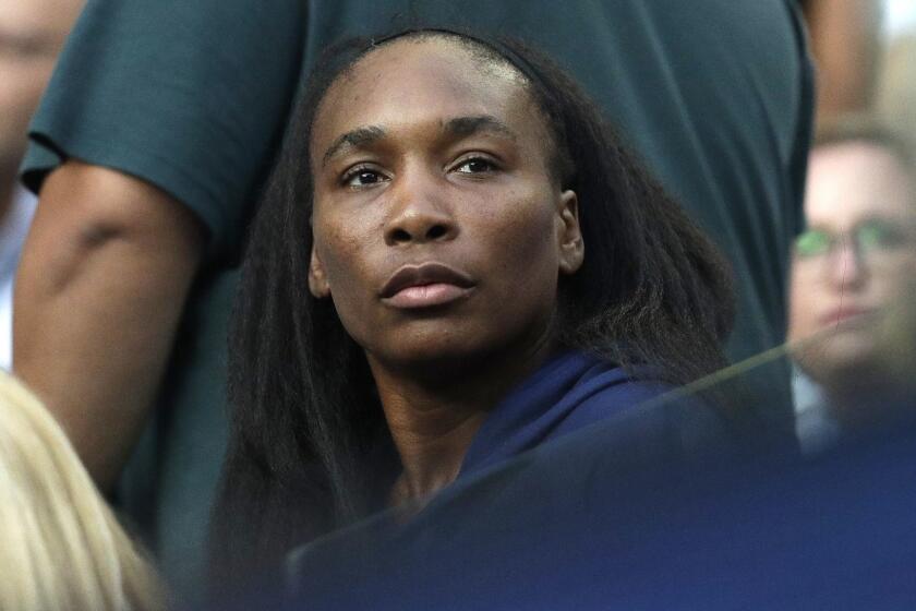 Venus Williams watches her sister Serena's fourth round match against Romania's Simona Halep at the Australian Open tennis championships in Melbourne, Australia, Monday, Jan. 21, 2019. (AP Photo/Kin Cheung)