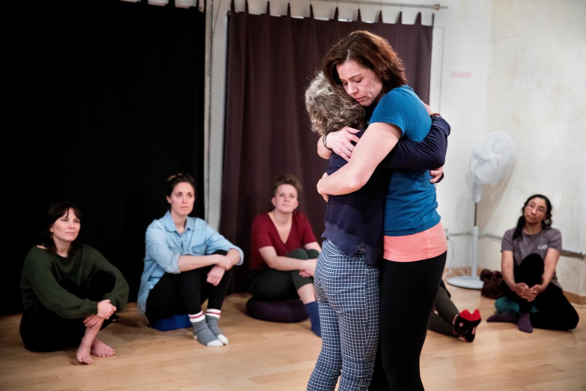 Claire Warden, intimacy director and intimacy coordinator, center right, and Fay Simpson, founder of Lucid Body House and apprentice at Intimacy Directors International, choreograph a hug during an intimacy direction workshop at Lucid Body House in New York City.