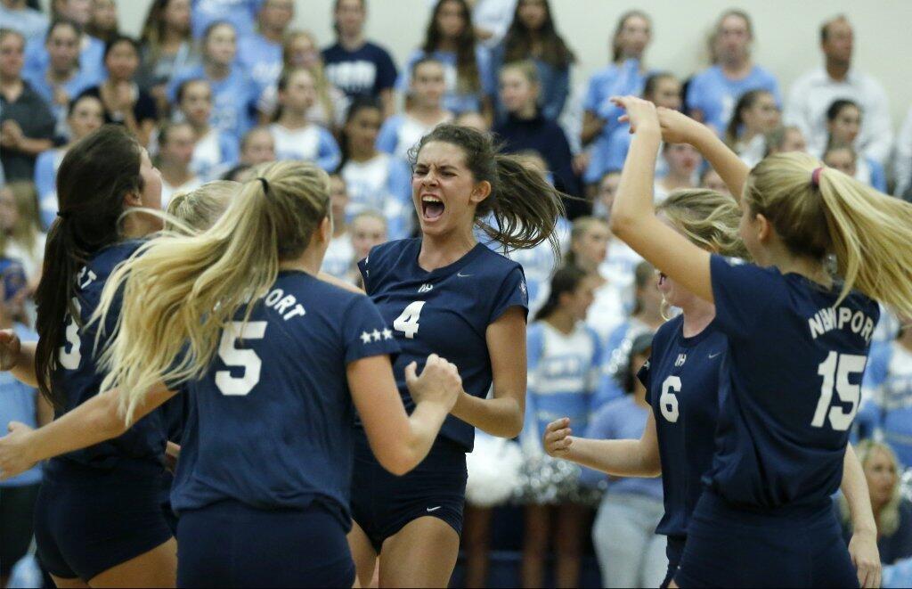 Newport Harbor High's Vivian Donovan (4) celebrates a point with teammates in the Battle of the Bay against Corona del Mar.