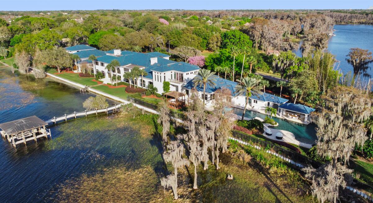 A sprawling mansion sits near water