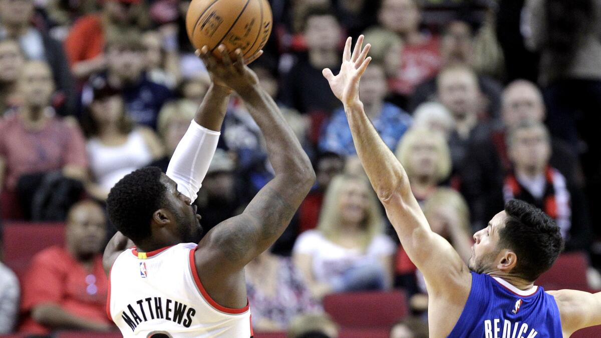 Wesley Matthews shoots over Clippers guard J.J. Redick during a game with the Portland Trail Blazers last season.
