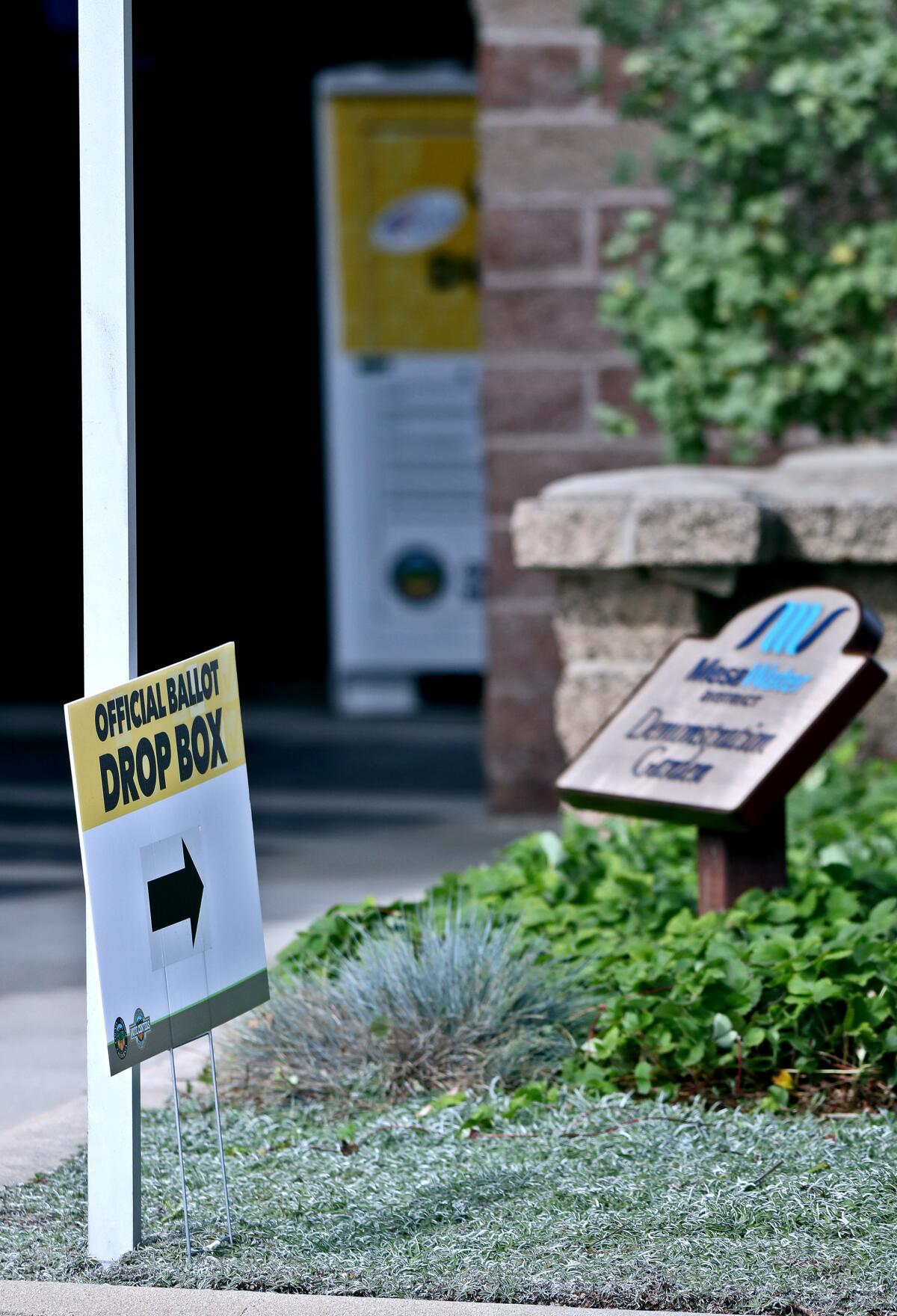 A sign points to an official ballot box located near the front door of the Mesa Water District.