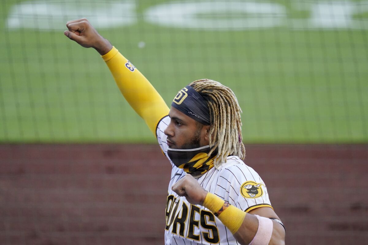 San Diego Padres shortstop Fernando Tatis Jr. reacts in the dugout after a home run by teammate Jake Cronenworth during the second inning of a baseball game against the Arizona Diamondbacks, Friday, Aug. 7, 2020, in San Diego. (AP Photo/Gregory Bull)