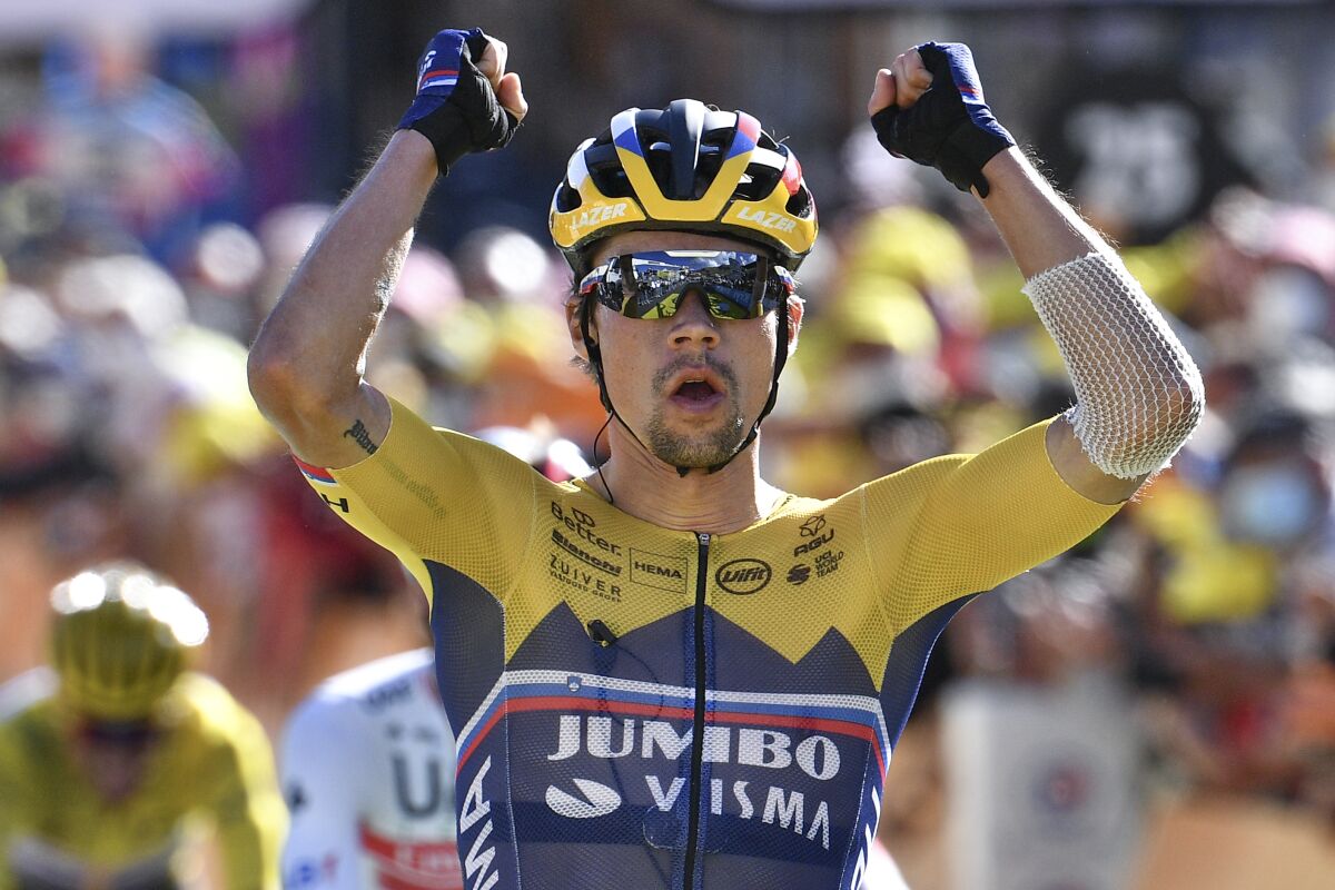 Slovenia's Primoz Roglic celebrates as he crosses the finish line to win the fourth stage of the Tour de France cycling race over 160,5 kilometers (99,7 miles) with start in Sisteron and finish in Orcieres-Merlette, southern France, Tuesday, Sept.1, 2020. (Anne-Christine Poujoulat, Pool via AP)