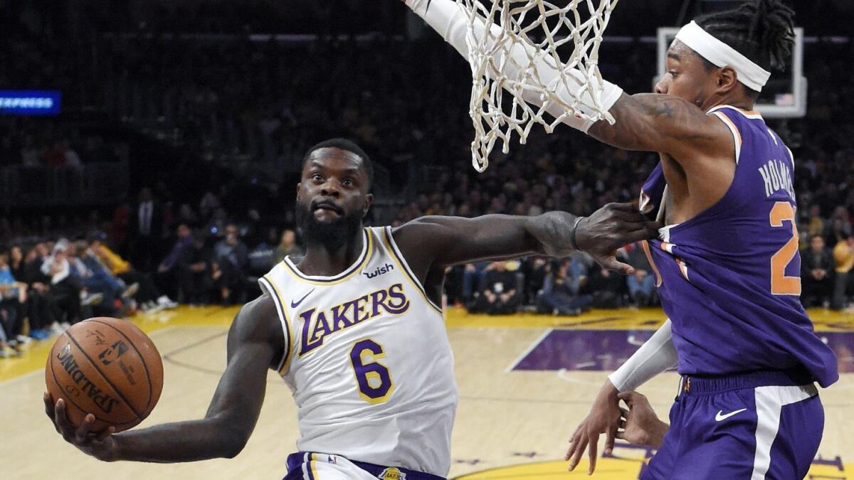 Lakers guard Lance Stephenson shoots as Phoenix forward Richaun Holmes defends on Jan. 27 at Staples Center.