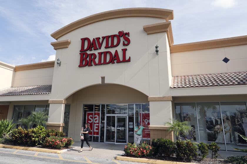 The entrance to a David's Bridal store is seen Monday, Nov. 19, 2018, in Orlando, Fla. David's Bridal is filing for bankruptcy protection but there is no danger for customers who have ordered dresses because operations are continuing as normal while the wedding and prom retailer restructures. (AP Photo/John Raoux)