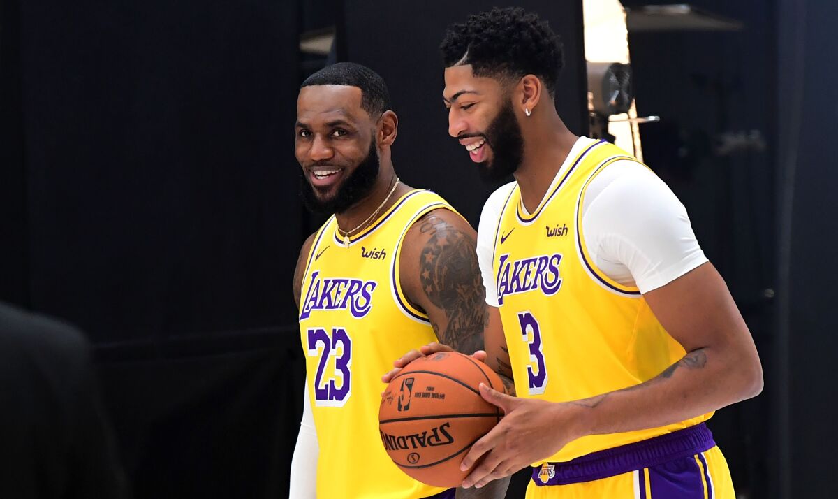 New Lakers teammates LeBron James (23) and Anthony Davis are all smiles during media day Friday at the team's training facility in El Segundo.
