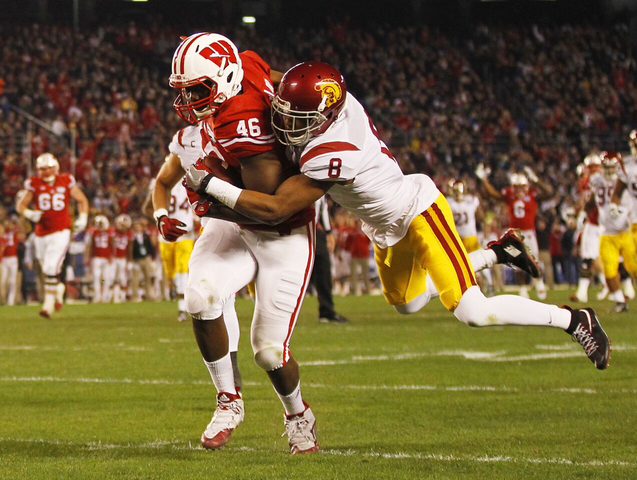 Wisconsin receiver Austin Traylor (46) makes a catch despite the tight coverage by USC defensive back Iman Marshall.
