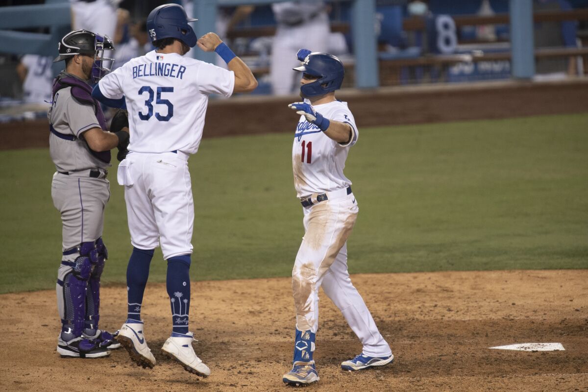 Los Angeles Dodgers' A.J. Pollock, right, celebrates his two-run home run with Cody Bellinger during the eighth inning of the team's baseball game against the Colorado Rockies in Los Angeles, Friday, Sept. 4, 2020. (AP Photo/Kyusung Gong)