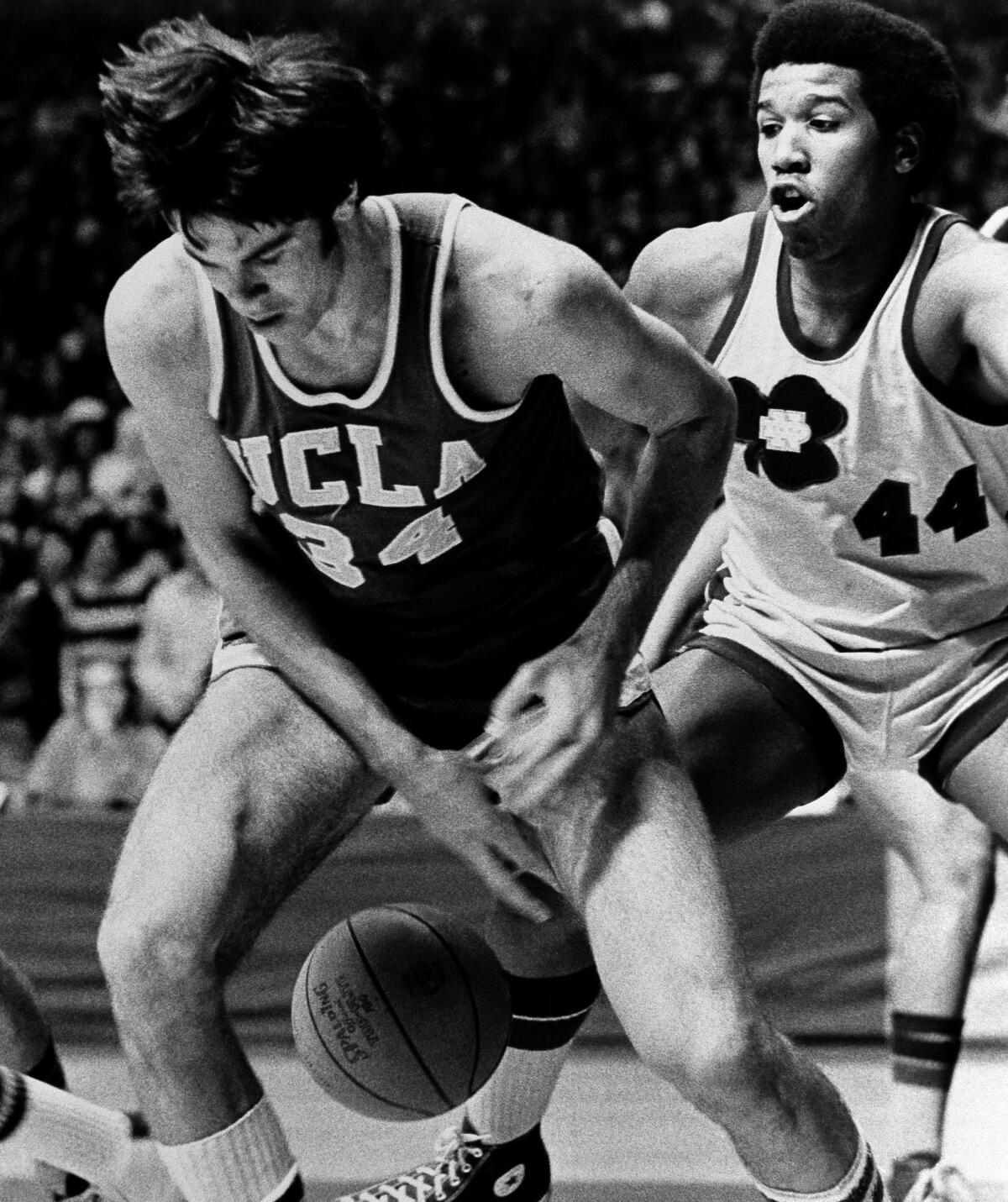 UCLA's Dave Meyers looks for the ball after losing it against Notre Dame's Adrian Dantley in January 1974 in South Bend, Ind.
