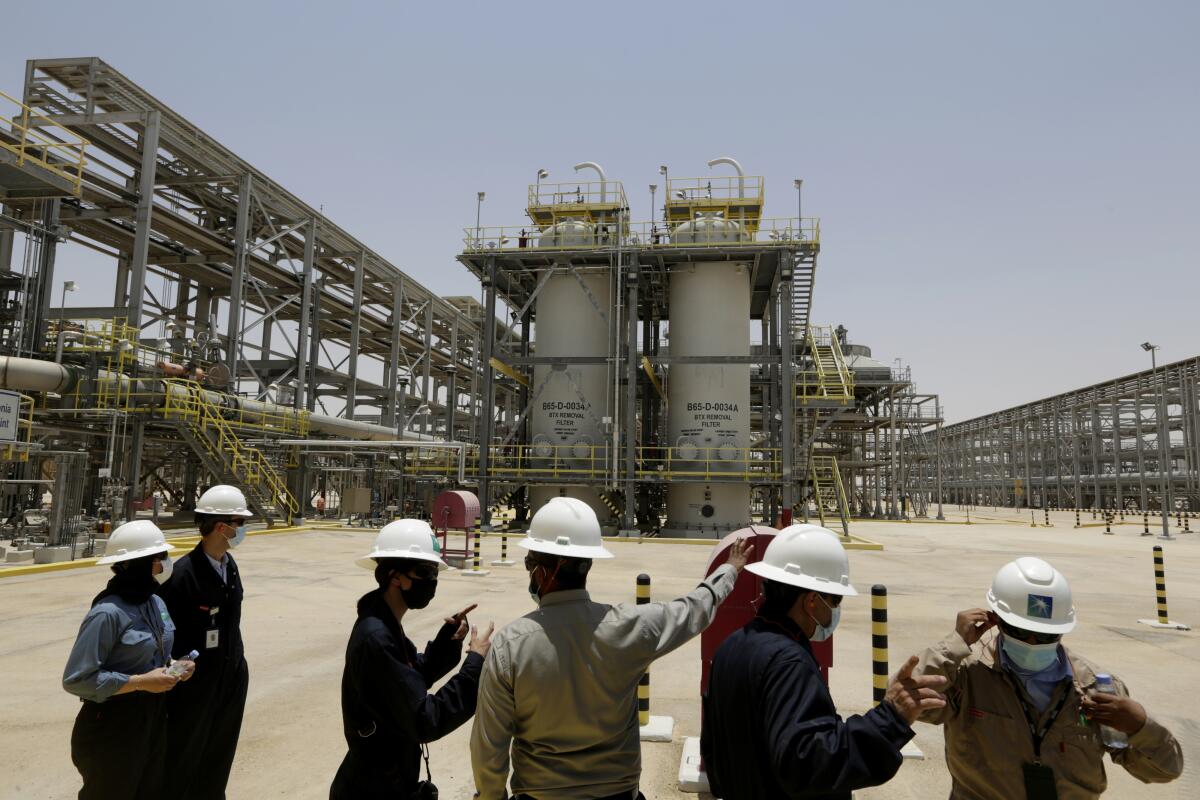 Engineers and journalists in hard hats at the Hawiyah Natural Gas Liquids Recovery Plant