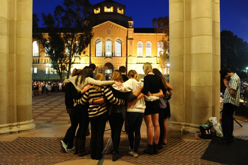 Students observe a moment of silence near Royce Hall at UCLA during a tribute to the Isla Vista victims.