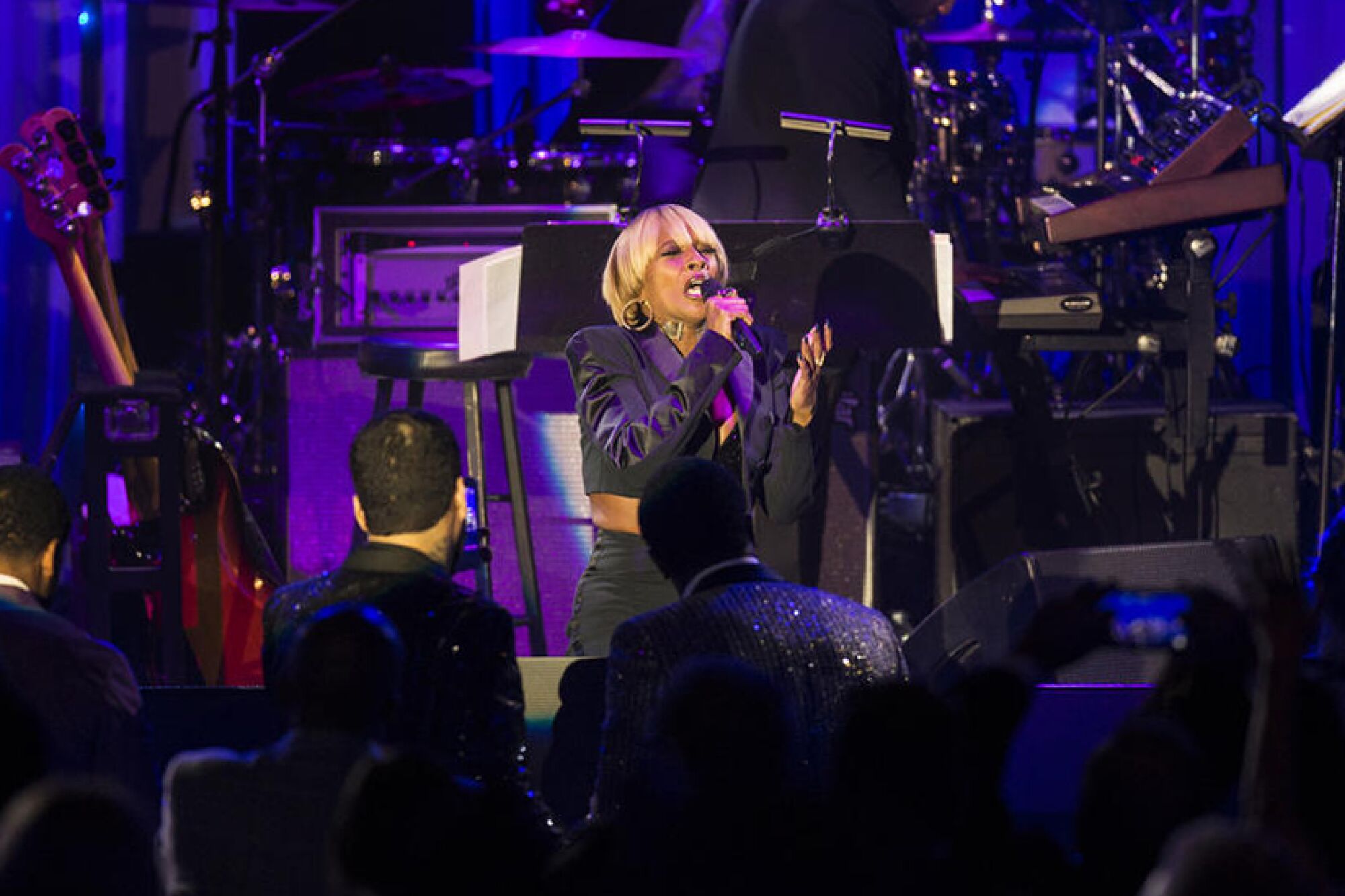A woman singing onstage.