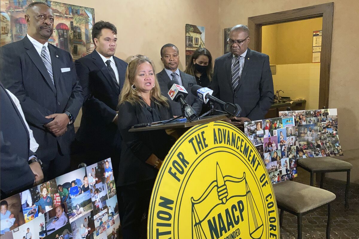 FILE - Eva Bruns speaks at a news conference in Spanish Lake, Mo., on Nov. 11, 2021, calling for a more thorough investigation of the death of her son, 28-year-old Justin King. To the right of Bruns is Justin King's father, John Alexander King. Justin King was shot by a white neighbor at a trailer court in Bourbon, Mo., on Nov. 3. A coroner's inquest jury on Tuesday, Jan. 11, 2022, began hearing the case involving the death of King. (AP Photo/Jim Salter File)