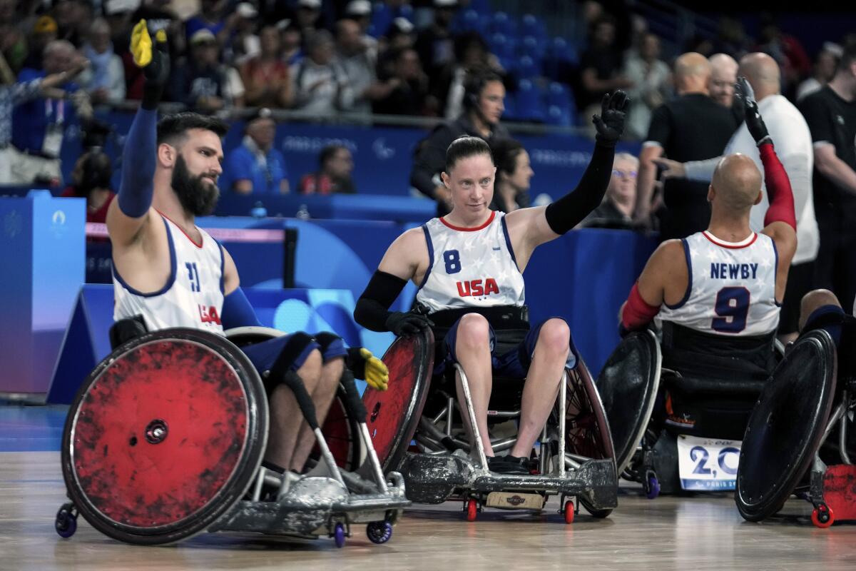 Americans Clayton Brackets and Sarah Adam acknowledge applause after they beat Canada during a Paralympics rugby match