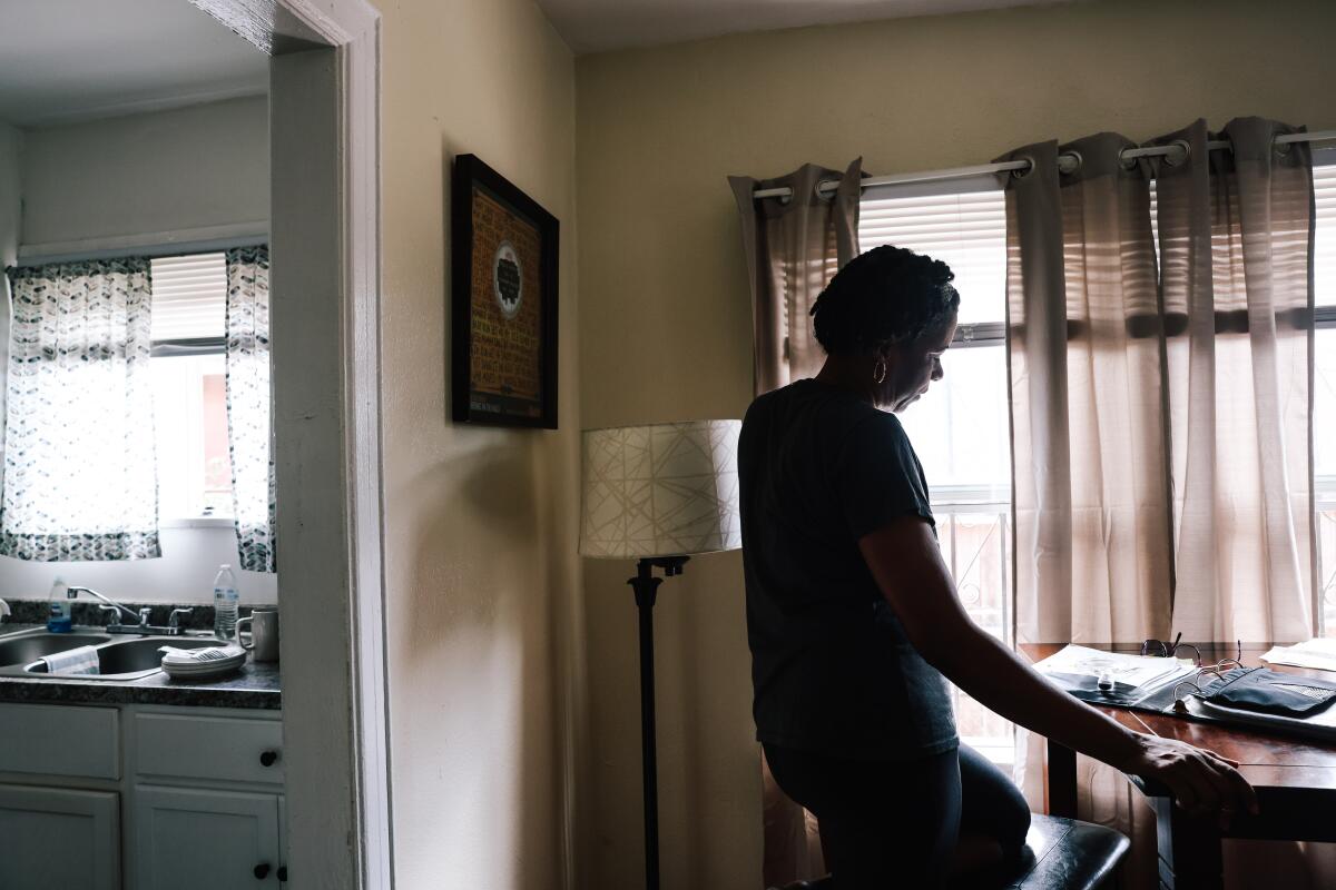 A person is silhouetted in a home.