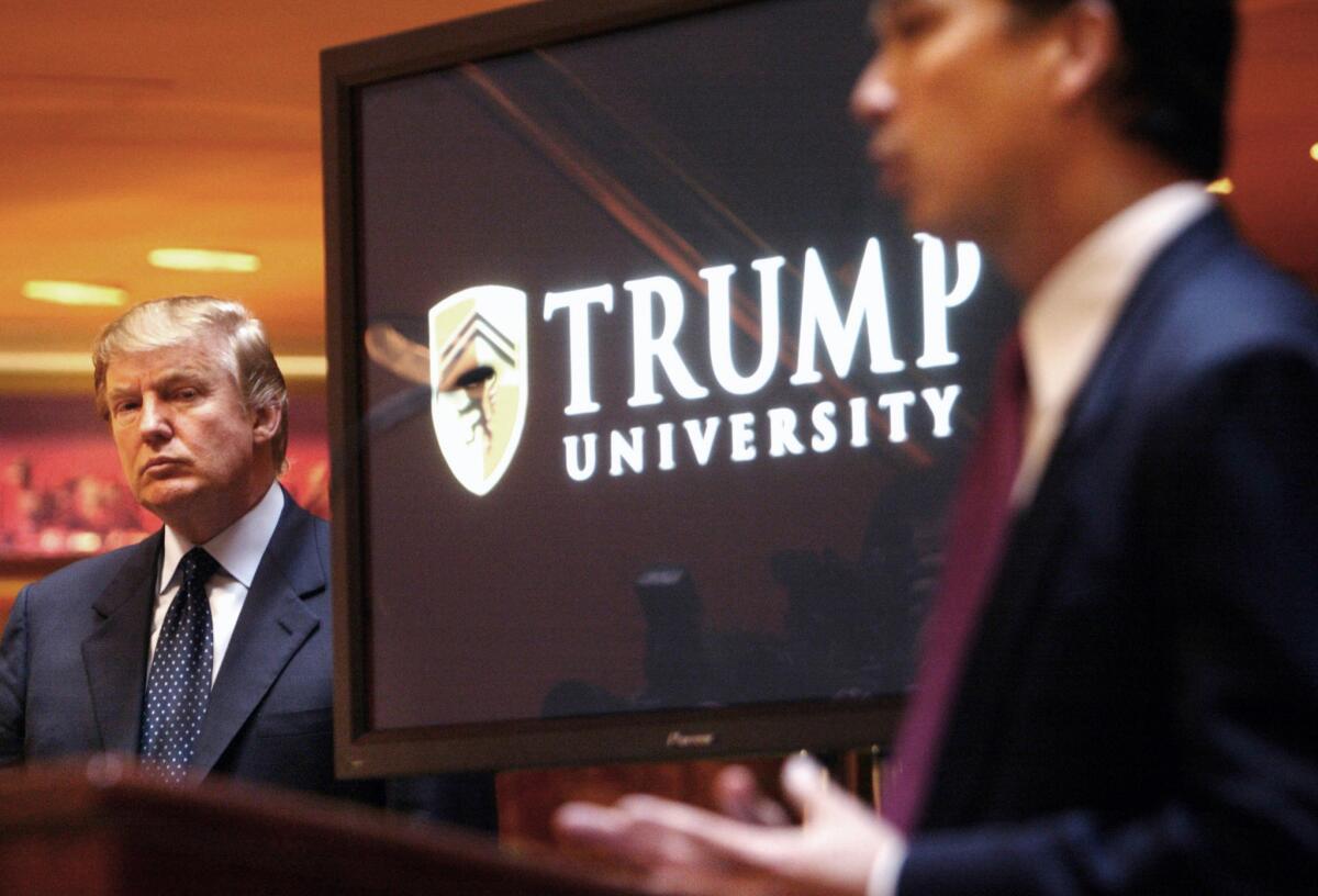 In this May 23, 2005, file photo, real estate mogul and Reality TV star Donald Trump, left, listens as Michael Sexton introduces him at a news conference in New York where he announced the establishment of Trump University.