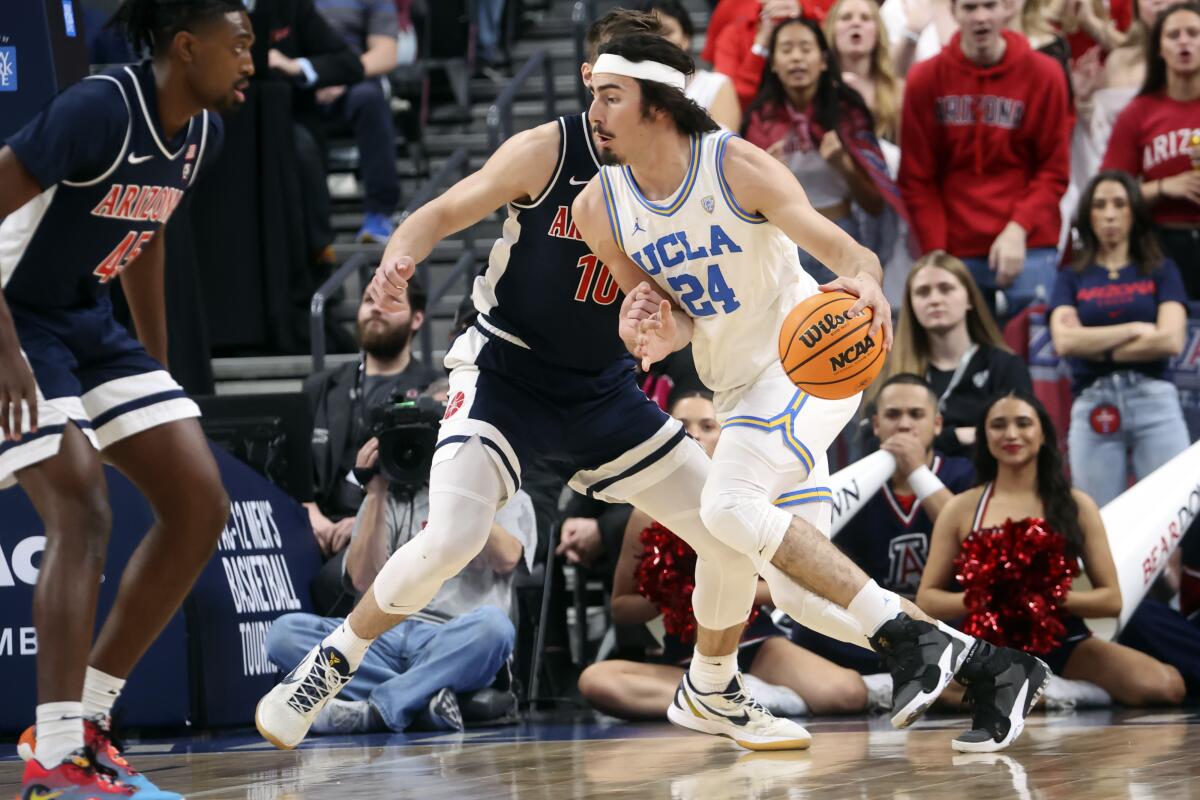 UCLA's Jaime Jaquez Jr. handles the ball against Arizona's Azuolas Tubelis during the first half.