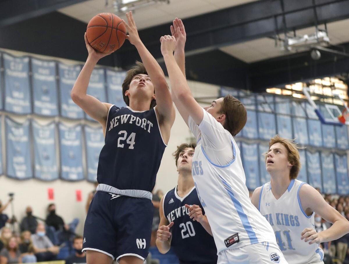 Newport Harbor's Tyler Li (24) drives the lane for a tough basket.