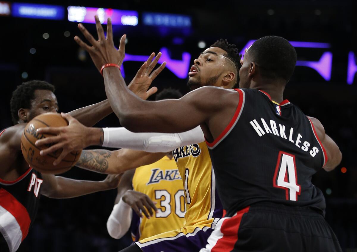 Lakers guard D'Angelo Russell takes on Portland's Maurice Harkless on Oct. 11.