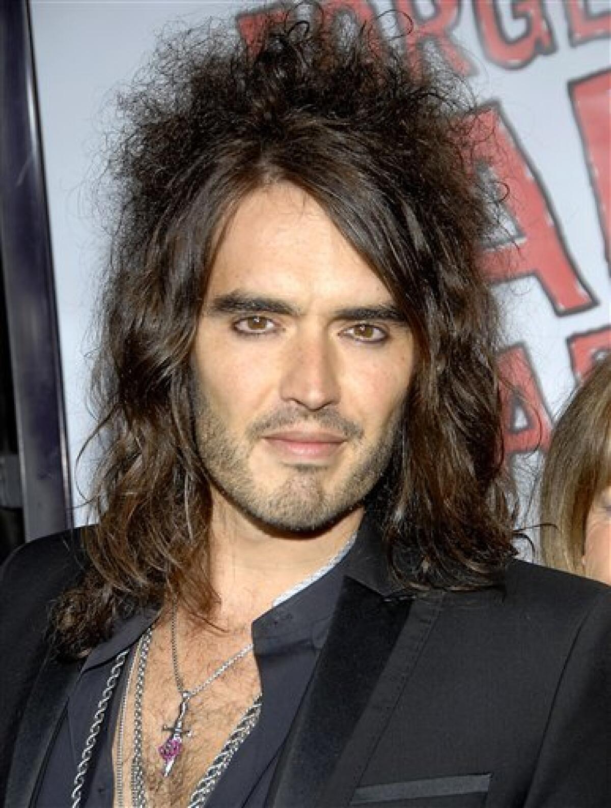 In this April 10, 2008 file photo, Russell Brand poses on the press line at the premiere of "Forgetting Sarah Marshall" in Los Angeles. Brand and Jonathan Ross, popular BBC broadcasters, were indefinitely suspended, Wednesday, Oct. 29, 2008, for leaving a series of lewd phone messages on an actor's answering machine. (AP Photo/Dan Steinberg, file)