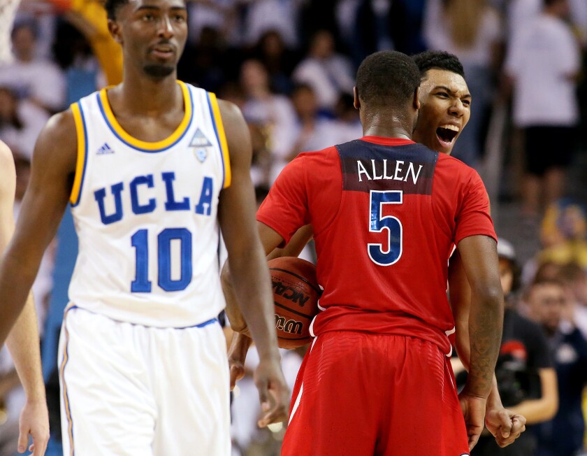 Arizona guards Kadeem Allen and Allonzo Trier celebrate a 96-85 victory over UCLA and Isaac Hamilton on Saturday at Pauley Pavilion.
