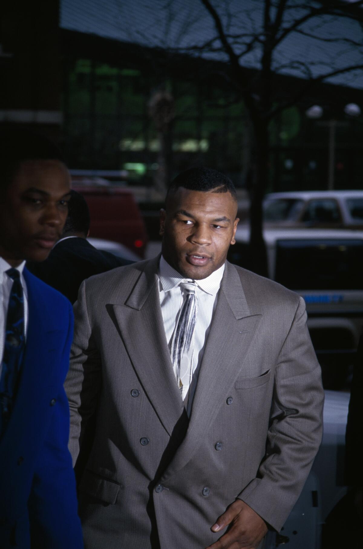 Mike Tyson in a suit entering court 