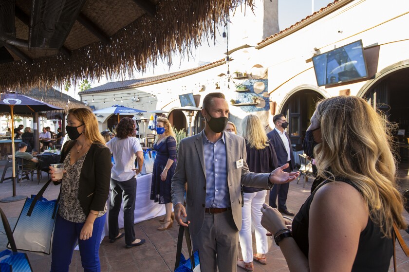 Costa Mesa Chamber of Commerce members socialize during a mixer at La Vida Cantina in Costa Mesa on Wednesday, October 14.