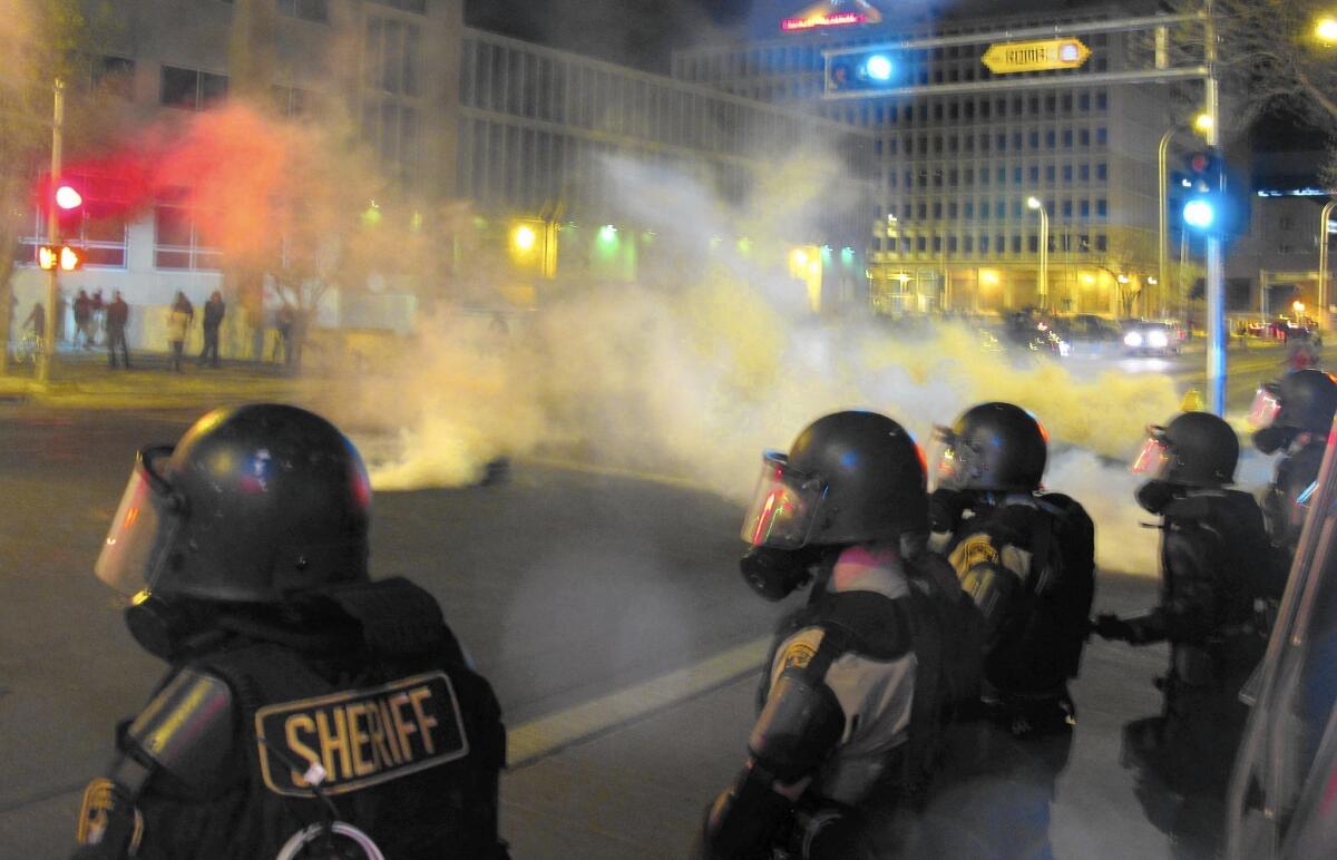 Riot police fire tear gas toward protesters gathered in downtown Albuquerque after the March 2014 police killing of James Boyd, a mentally ill homeless man.
