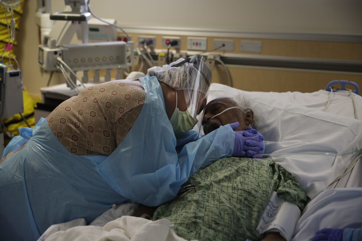 Romelia Navarro, 64, weeps while hugging her husband, Antonio, in July