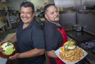Mixing both of their Mexican and Pilipino heritages, Richard Corpus (l) and Roger Buhain (r) hold two of the popular dishes served at their new restaurant in Chula Vista, MexiPino Hash and the MexiPino Breakfast Sandwich.
