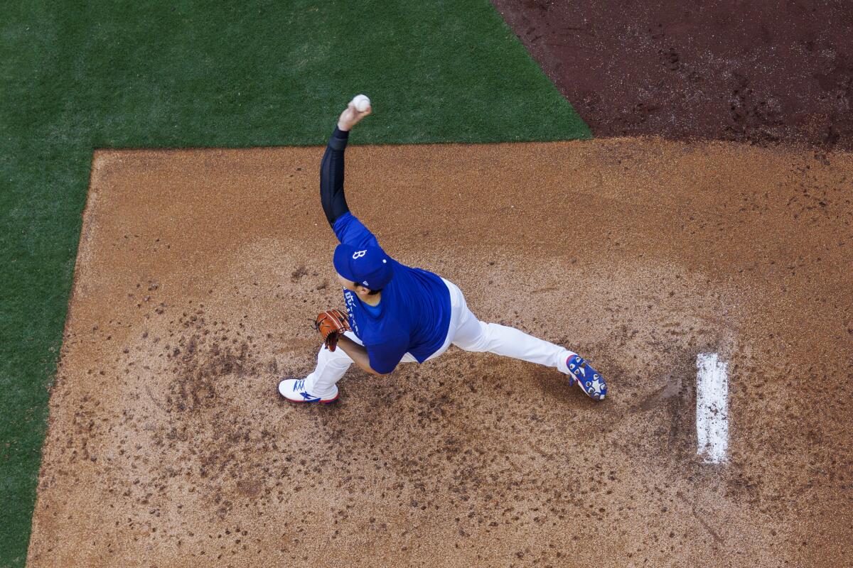 Shohei Ohtani pitches in the bullpen before a game earlier this month.