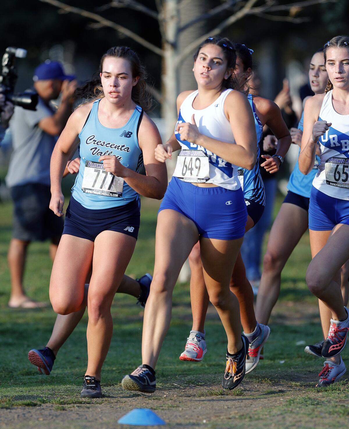 Crescenta Valley's Sophia Atin and Burbank's Sol Fernandez lead the runners at an early turn in a Pacific League cross country meet at Arcadia Park in Arcadia on Thursday, November 7, 2019. This is the final league meet of the season.