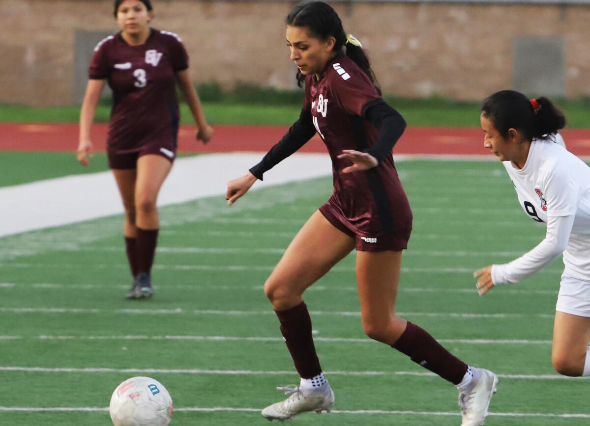 Ocean View's Isis Salazar (14) dribbles past a Katella defender during Tuesday night's match.