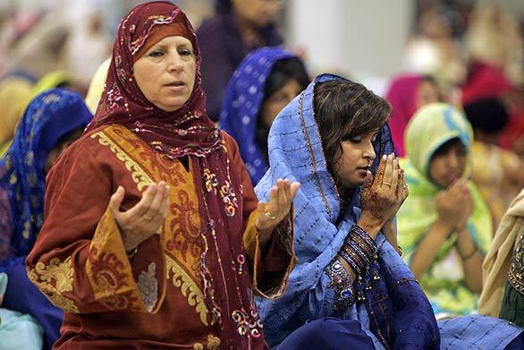 Muslim women pray with hundreds of others during an Eid prayer service held by the Islamic Society of Orange County at the Anaheim Convention Center to mark the end of the holy month of Ramadan.