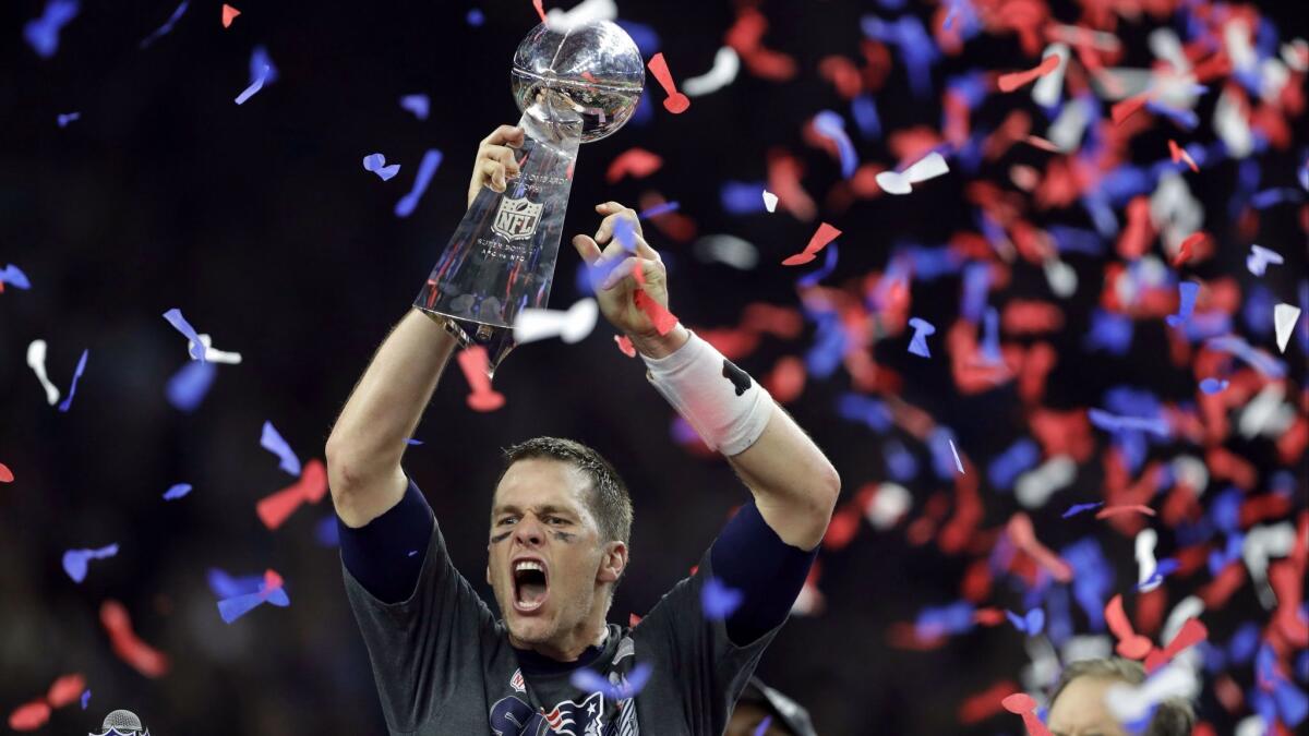 Patriots QB Tom Brady raises the Vince Lombardi Trophy after defeating the Atlanta Falcons in overtime at the Super Bowl in February.