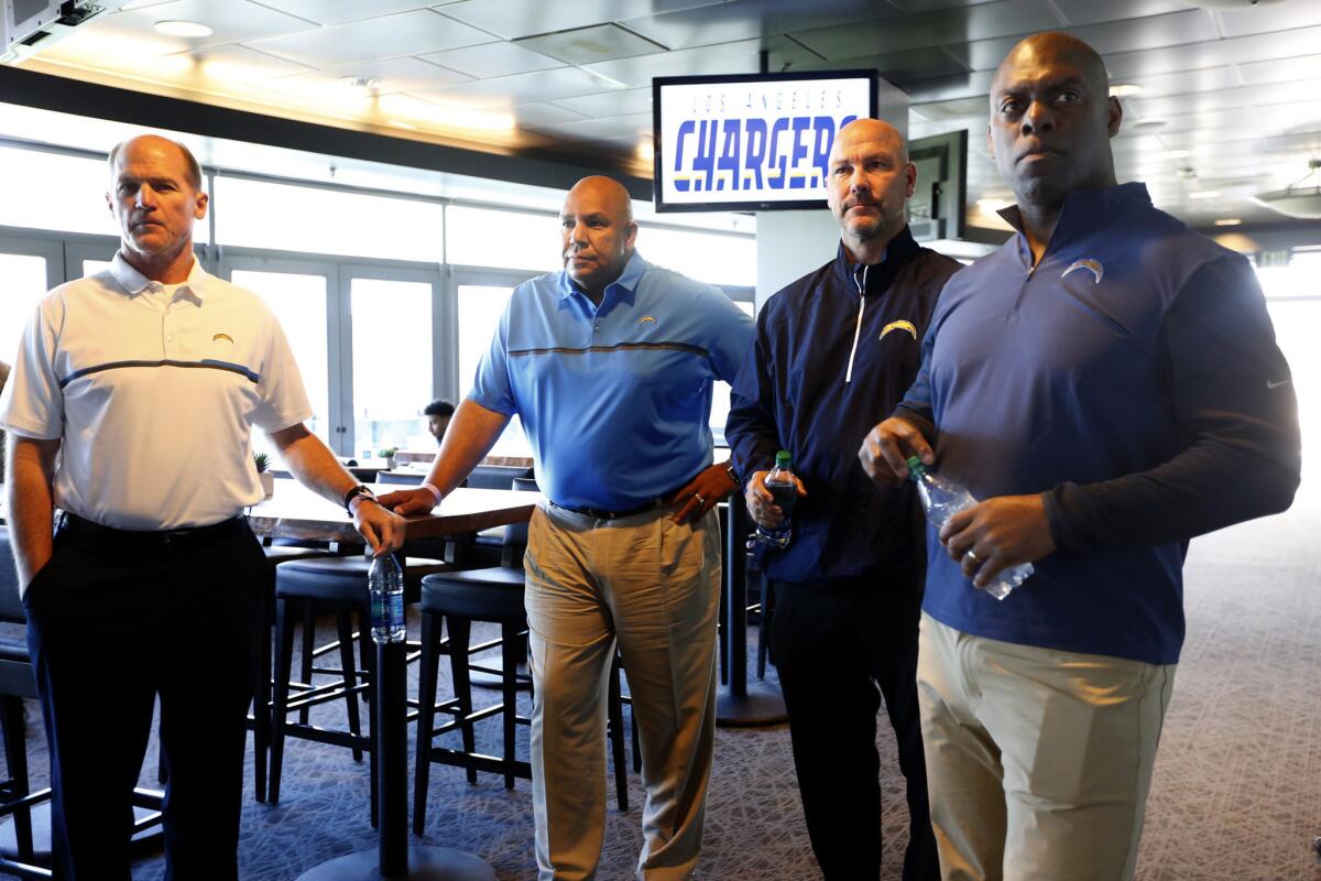 Chargers Coach Anthony Lynn, from right, stands with new additions to the team, including defensive coordinator Gus Bradley, special team coordinator-assistant coach George Stewart and offensive coordinator Ken Whisenhunt, before being introduced to the media on Feb. 21.