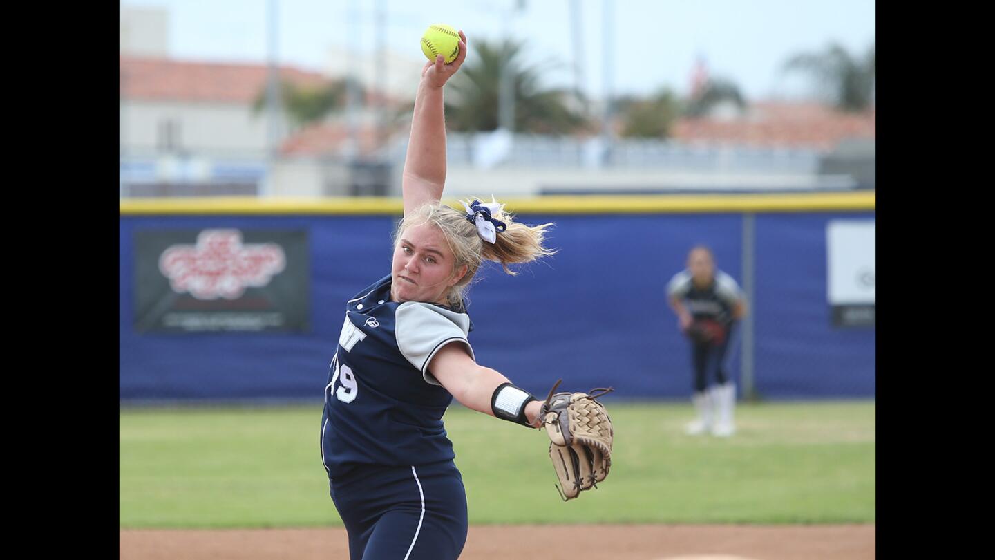 Newport pitcher Clare Austin makes a pitch early in the game during Battle of the Bay girls softball game against Corona del Mar on Tuesday.
