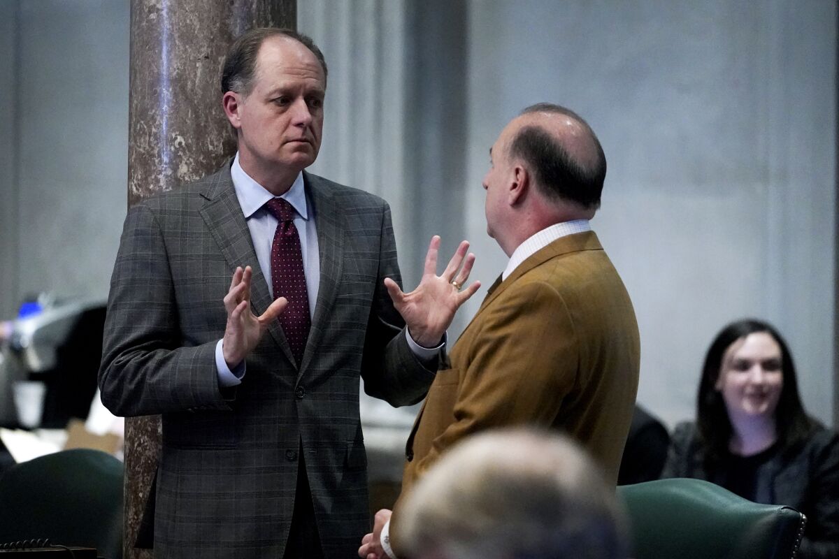 Sen. Jack Johnson, R-Franklin, left, talks on the Senate floor Wednesday, Oct. 27, 2021, in Nashville, Tenn. Tennessee's General Assembly is meeting for a special legislative session to address COVID-19 measures after Republican Gov. Bill Lee declined to do so. (AP Photo/Mark Humphrey)