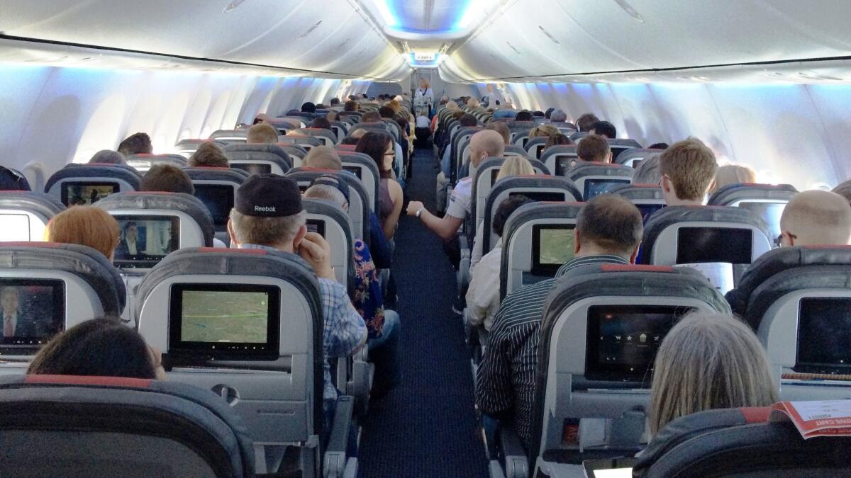 Passengers on an American Airlines 737 jet. A U.S. senator released a report accusing airlines of confusing consumers with new seat categories. Airlines say they are giving fliers more choices.