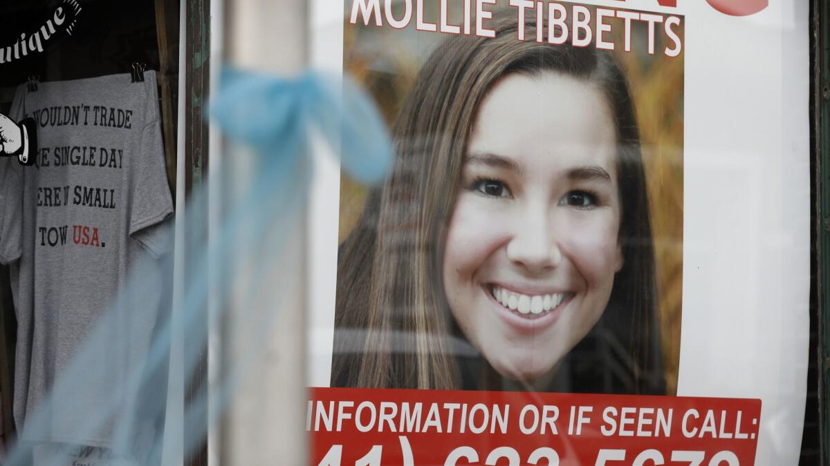 A poster for missing University of Iowa student Mollie Tibbetts hangs in the window of a business in Brooklyn, Iowa, on Aug. 21. She was later found dead.