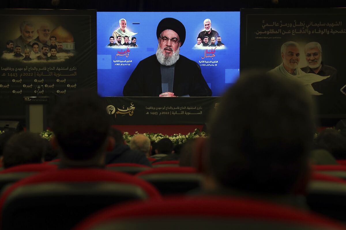 Hezbollah leader Sayyed Hassan Nasrallah speaks via a video link during a ceremony to mark the second anniversary of the assassination of the head of Iran's Quds force General Qassem Soleimani, who was killed in a U.S. drone strike in Baghdad, in the southern Beirut suburb of Dahiyeh, Lebanon, Monday, Jan. 3, 2022. (AP Photo/Bilal Hussein)