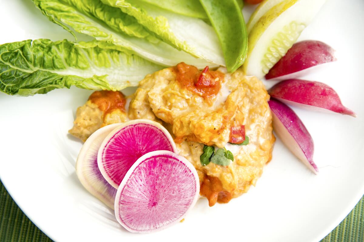 Eggplant dip on a plate with fruit and vegetables.