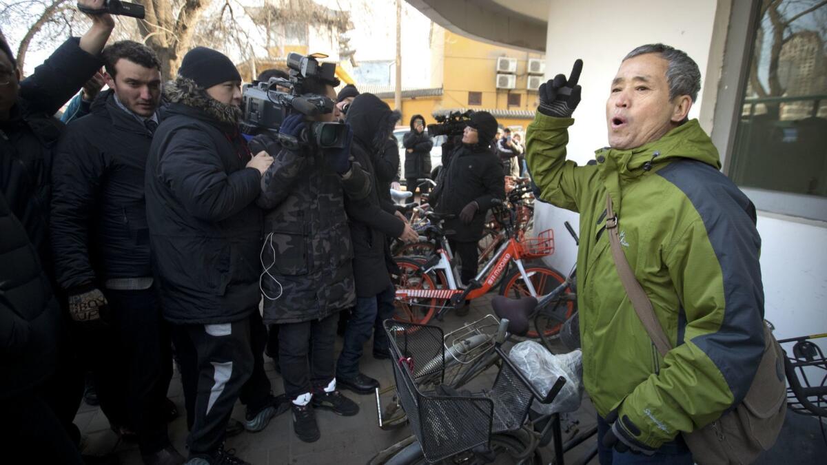 A supporter of Chinese human rights lawyer Wang Quanzhang speaks near the Secondary Intermediate People's Court of Tianjin in Tianjin, China, on Dec. 26.
