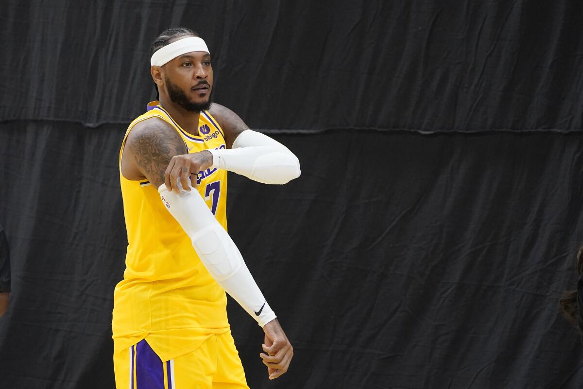 Lakers forward Carmelo Anthony walks onto the court during media day.