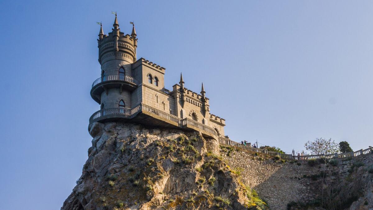 The castle called Swallow’s Nest stands on a cliff in Crimea by the Black Sea.