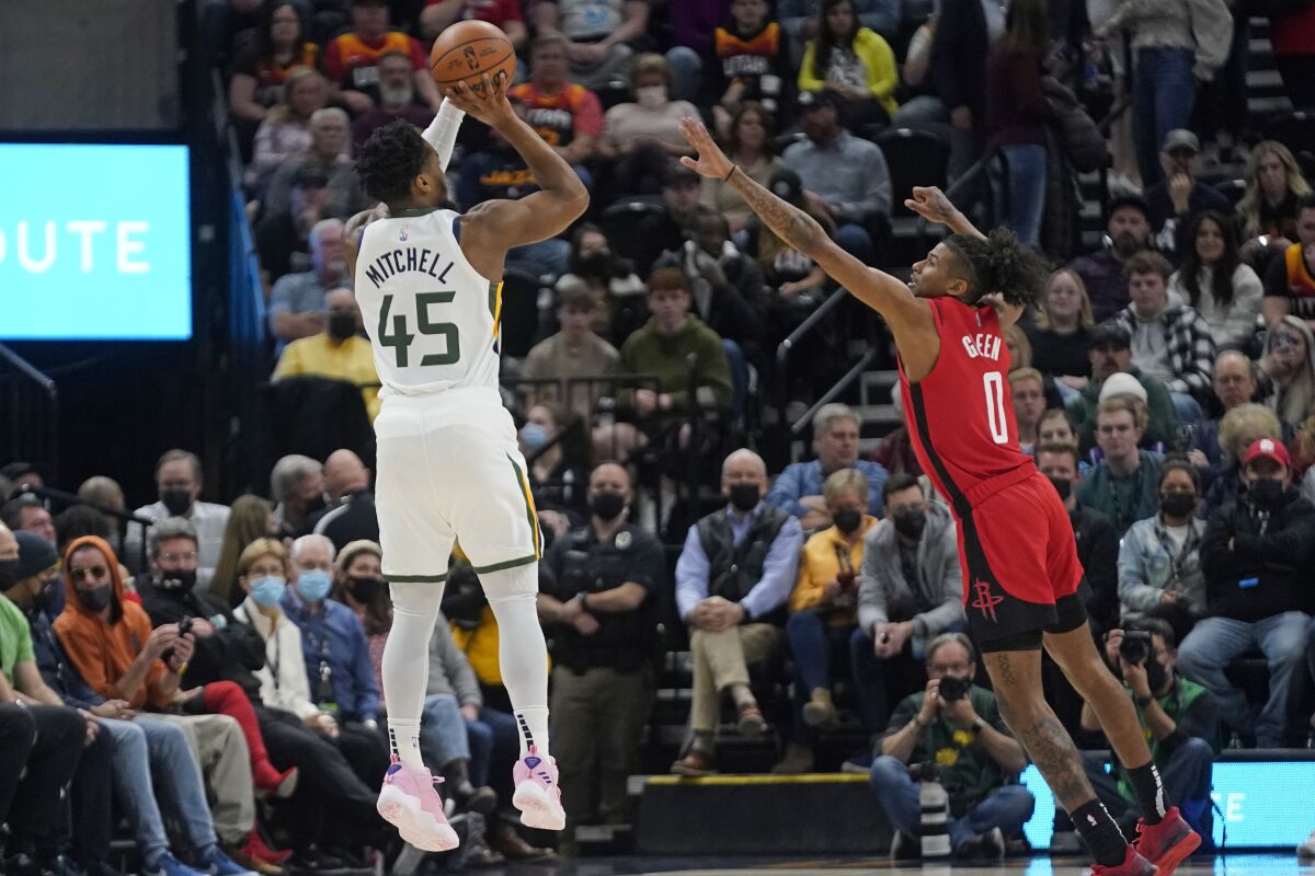 Utah Jazz guard Donovan Mitchell (45) shoots as Houston Rockets guard Jalen Green (0) defends in the first half during an NBA basketball game Monday, Feb. 14, 2022, in Salt Lake City. (AP Photo/Rick Bowmer)