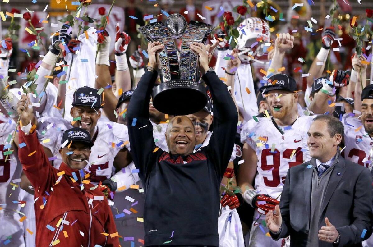 "I don't live with regrets," Stanford Coach David Shaw, shown here holding up the Pac-12 title trophy, said. "I know there's going to be bumps in the road and a whole bunch of games where they're on the edge of a knife."